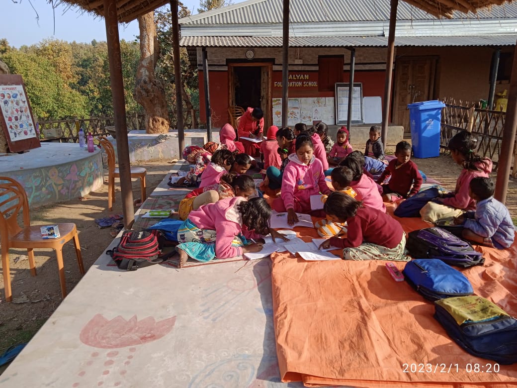 Children in pink uniforms engaged in art and creative activities at the foundation