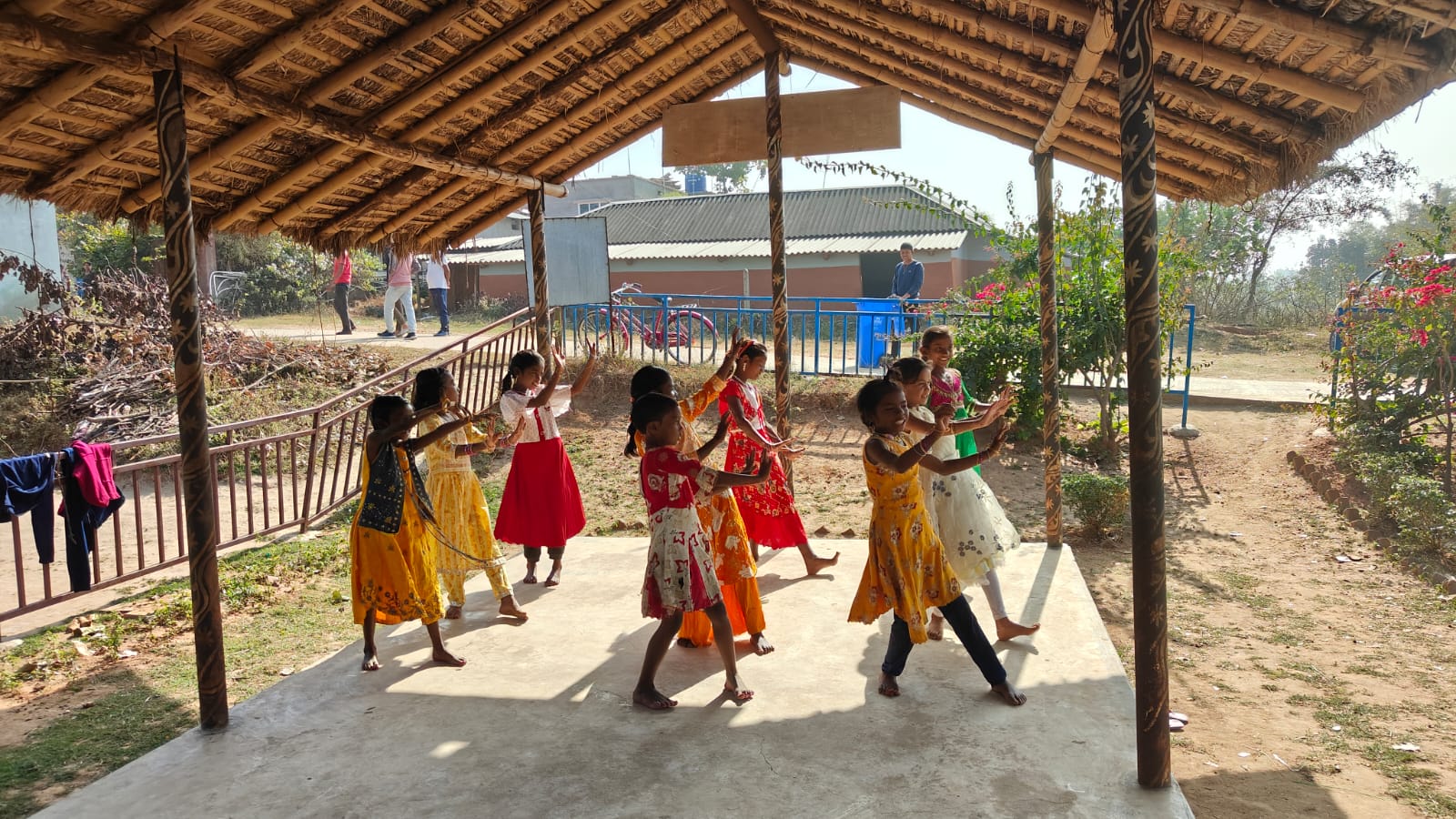 Children in colorful clothing participating in outdoor physical activities and dance