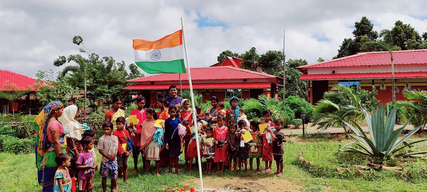 Community members gathered with Indian flag celebrating independence day
