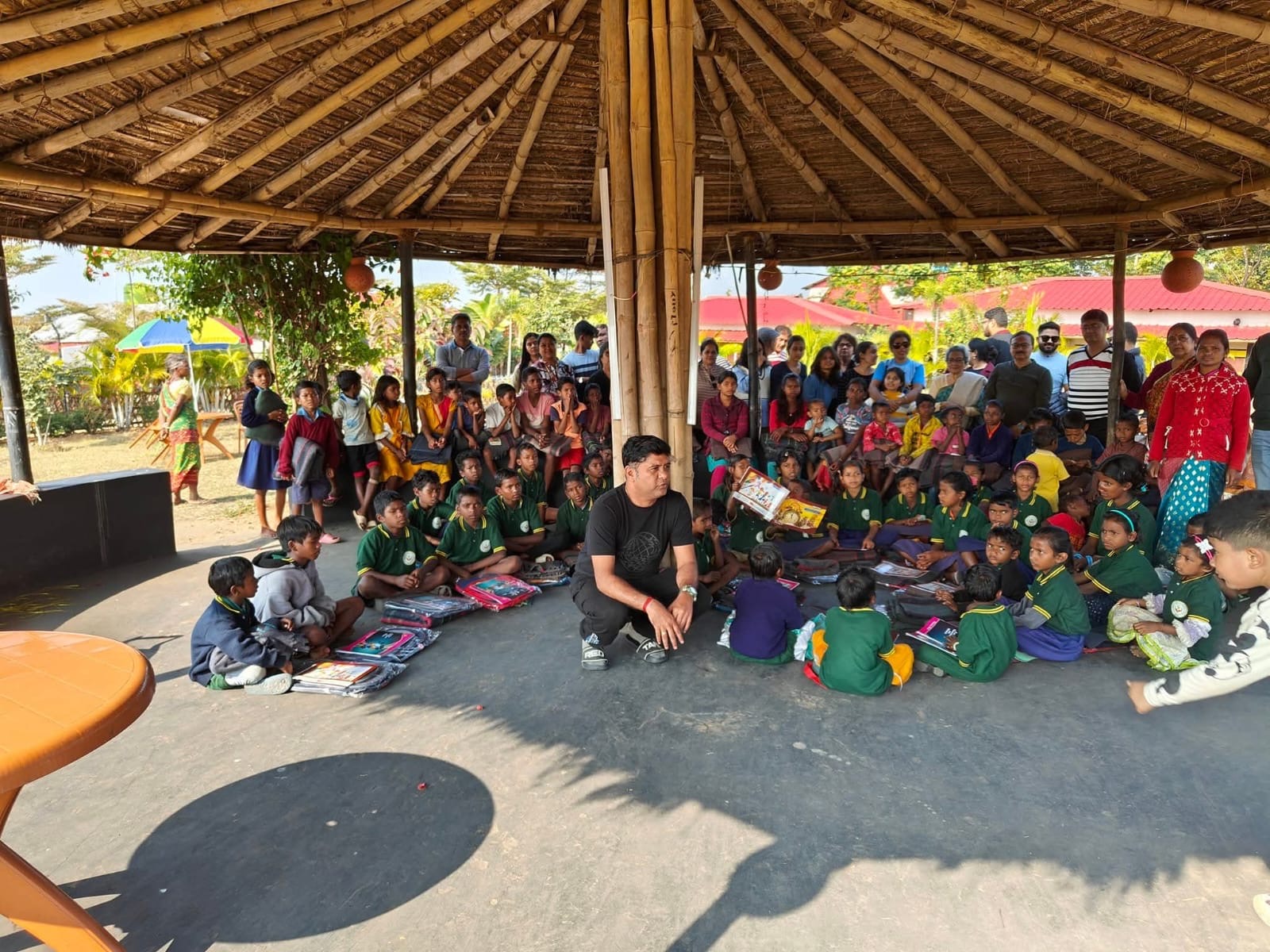 Community leader engaging with children during an educational session